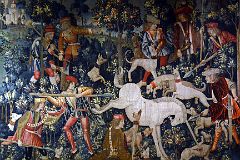 New York Cloisters 57 017 Unicorn Tapestries - The Unicorn Defends Itself - the injured unicorn is held at bay by 3 hunters ready to pierce him with their lances
